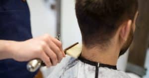 Man bij barbier die zijn nekhaar laat scheren