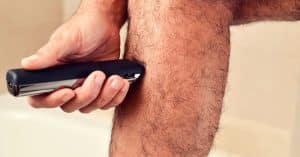 Mannen been met haar wat zelf getrimd wordt door een trimmer